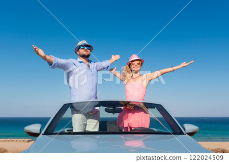Happy couple in love travel by car by the sea 122024509
