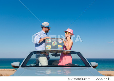 Happy couple in love travel by car by the sea 122024510