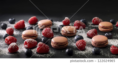 macaroons of different colors on a black background 122024965