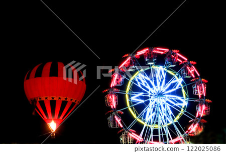 A hot air balloon lit up the night sky.  122025086