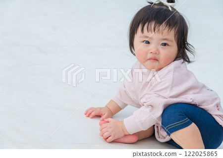 [Infants sitting on giant playground equipment] 122025865