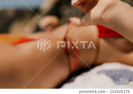 Woman taking red bikini off on beach for tan, lady stripping holiday swimsuit with bow in string. Fun and relax, sexy model untying swimming costume bra, happy woman in swimwear on vacation Woman taking red bikini off on beach for tan, lady stripping holiday swimsuit with bow in string. Fun and relax, sexy model untying swimming costume bra, happy woman in swimwear on vacation 122026176