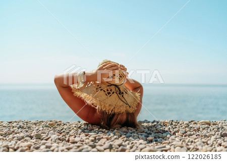 Beach Relaxation woman lies on a pebble beach. The concept of travel, vacation at sea 122026185