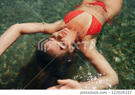 Happy woman sea relaxing floating in transparent sea water on summer holiday. Travel leisure recreation lifestyle, female in nature. 122026187