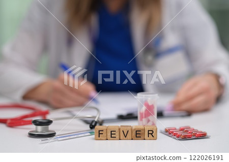 A doctors desk displays essential fever medications and equipment vital for patient care A doctors desk displays essential fever medications and equipment vital for patient care 122026191