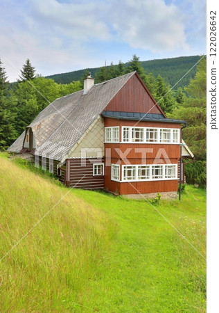 Beautiful wooden cottage during summer 122026642