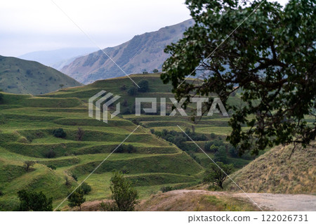 Chokhsky terraces Dagestan. Landscape of mountainous Dagestan with terraced fields and peaks mountains in the distance. 122026731