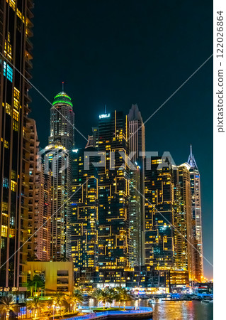 Night view on Dubai Marina skyscrapers, cruise boats and promenade in this luxury city, Dubai, United Arab Emirates. High quality photo 122026864