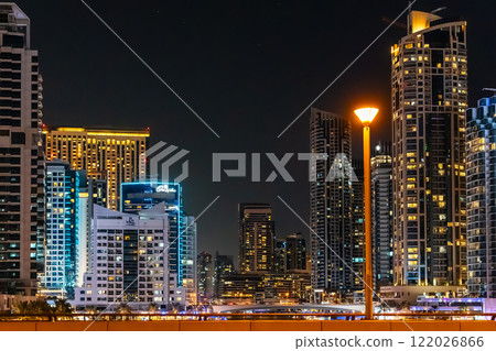 Night view on Dubai Marina skyscrapers, cruise boats and promenade in this luxury city, Dubai, United Arab Emirates. High quality photo 122026866