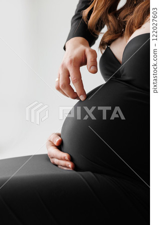Cropped shot loving husband hands imitation steps on pregnant wife belly, future parents touch and stroke big tummy, feel love, show protection. Medical insurance, IVF, parenthood, offspring, care. Cropped shot loving husband hands imitation steps on pregnant wife belly, future parents touch and stroke big tummy, feel love, show protection. Medical insurance, IVF, parenthood, offspring, care. 122027603