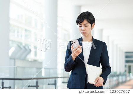 Business woman using a smartphone in the office 122027667