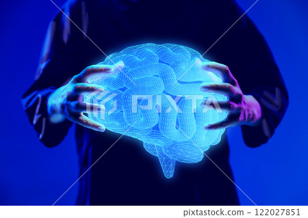 Hands holding glowing digital brain hologram, representing neuroscience research and medical innovation. 122027851
