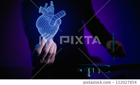Man holding a glowing digital heart model and making digital notes, symbolizing medical innovation and scientific research. 122027854