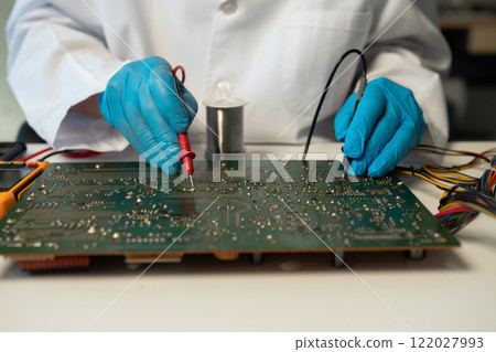 Close up of Technician measuring voltage electronic circuit board, Service after sale fix electric equipment. Close up of Technician measuring voltage electronic circuit board, Service after sale fix electric equipment. 122027993