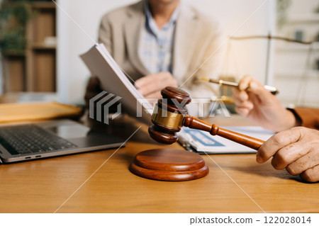 Teamwork of business lawyer meeting working hard about legal legislation in courtroom to help their customer Teamwork of business lawyer meeting working hard about legal legislation in courtroom to help their customer 122028014