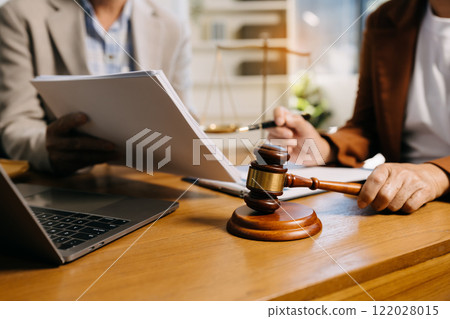 Teamwork of business lawyer meeting working hard about legal legislation in courtroom to help their customer 122028015