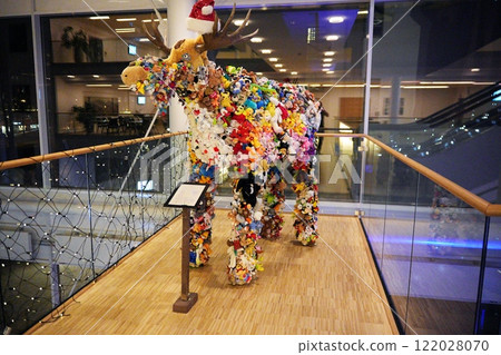 Stuffed Animal Moose Sculpture with Santa Hat on Indoor Display Stuffed Animal Moose Sculpture with Santa Hat on Indoor Display 122028070