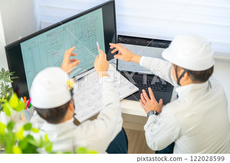 Male chief engineer explaining construction schedule, network schedule, construction supervision, helmet, 2 people Male chief engineer explaining construction schedule, network schedule, construction supervision, helmet, 2 people 122028599