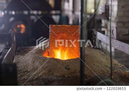 Ferrous metal billet is melted in an induction furnace closeup Ferrous metal billet is melted in an induction furnace closeup 122028653