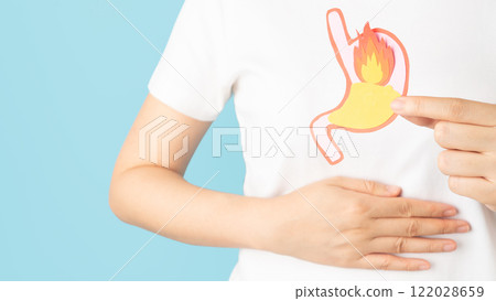 Woman suffering from stomach burn with acid reflux. Gastroesophageal reflux disease (GERD) or heartburn symptoms. Gastrointestinal system disease and digestive problems. 122028659