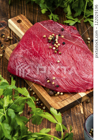 Seasoning Raw Beef Steaks. 122029196
