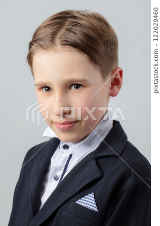Portrait of a funny boy in retro style with a classic hairstyle and in a suit. Portrait of a funny boy in retro style with a classic hairstyle and in a suit. 122029460