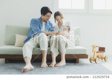 Young family, parents and children, living room Young family, parents and children, living room 122029758