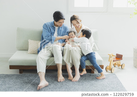 Young family, parents and children, living room Young family, parents and children, living room 122029759
