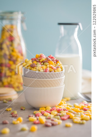 Colorful breakfast cereals in the shape of various fruit in bowl on kitchen table. 122029865