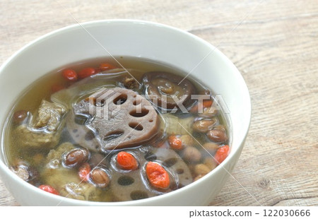 boiled lotus root with peanut and ginger couple pork bone in Chinese herb soup on bowl boiled lotus root with peanut and ginger couple pork bone in Chinese herb soup on bowl 122030666