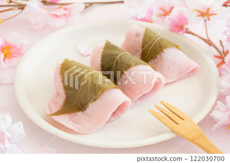 Cherry blossoms and sakura mochi on pink background 122030700