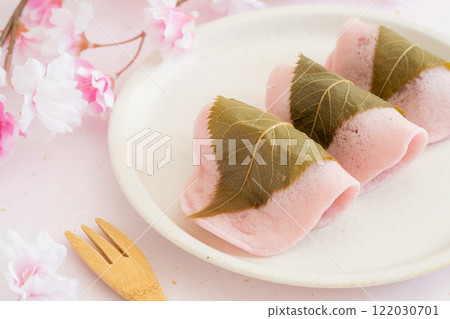 Cherry blossoms and sakura mochi on pink background 122030701