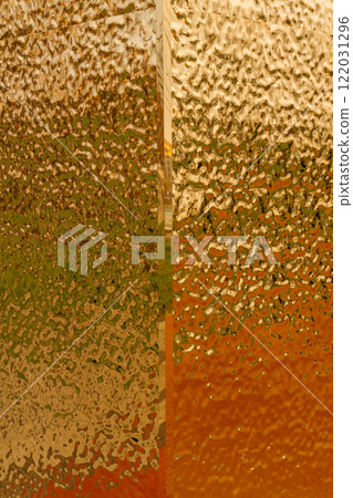 stamped gold-colored iron sheet. textured tin sheet on the wall 122031296