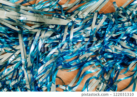 blue plastic ribbons for the holiday. tinsel texture for birthday decoration blue plastic ribbons for the holiday. tinsel texture for birthday decoration 122031310