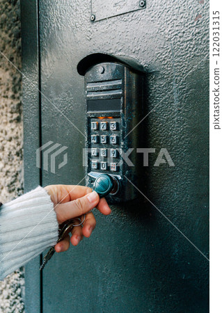 Magnetic intercom in an apartment building. Opening the front door lock with a magnet 122031315