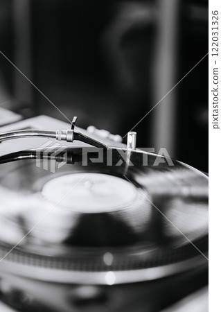 Black and white close-up of a vinyl record on a turntable, evoking timeless music and retro vibes Black and white close-up of a vinyl record on a turntable, evoking timeless music and retro vibes 122031326