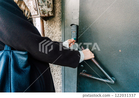Magnetic intercom in an apartment building. Opening the front door lock with a magnet Magnetic intercom in an apartment building. Opening the front door lock with a magnet 122031337