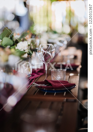 Elegant wine glass and water glass on a rustic table, perfect for fine dining and event settings Elegant wine glass and water glass on a rustic table, perfect for fine dining and event settings 122031367