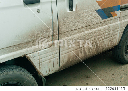 dirty white car on the city street. Mud-splattered truck in the city center dirty white car on the city street. Mud-splattered truck in the city center 122031415