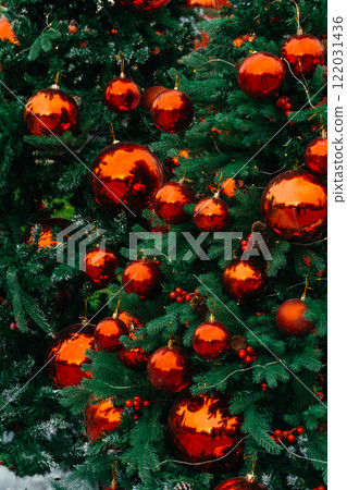 New Year's toys on the Christmas tree. festive Christmas decoration on an artificial Christmas tree 122031436