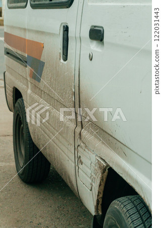 dirty white car on the city street. Mud-splattered truck in the city center dirty white car on the city street. Mud-splattered truck in the city center 122031443
