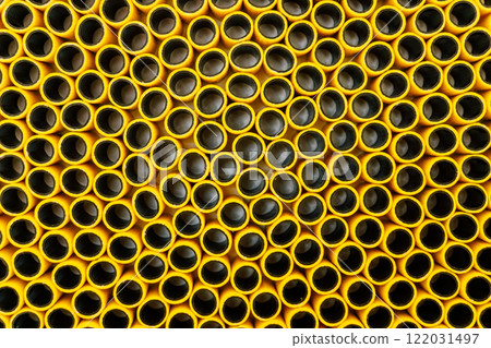 texture of yellow plastic hose. pieces of rubber hose stuck together 122031497