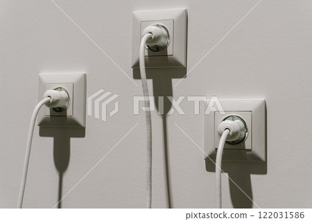 white electrical sockets with plugs in them. connecting high-voltage wire to the socket white electrical sockets with plugs in them. connecting high-voltage wire to the socket 122031586