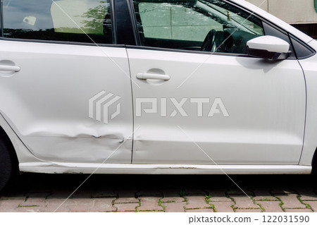 dented rear door of white car. damage to metal of car due to parking dented rear door of white car. damage to metal of car due to parking 122031590