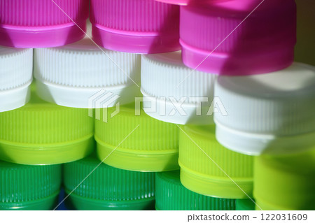 The pile of plastic caps of drinking water bottles. The pile of plastic caps of drinking water bottles. 122031609