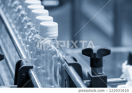 The  empty drinking water bottles  on the conveyor belt for filling process. 122031610