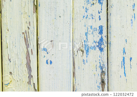 Wooden cracked background of an old white fence with blue paint beaches. Wooden cracked background of an old white fence with blue paint beaches. 122032472