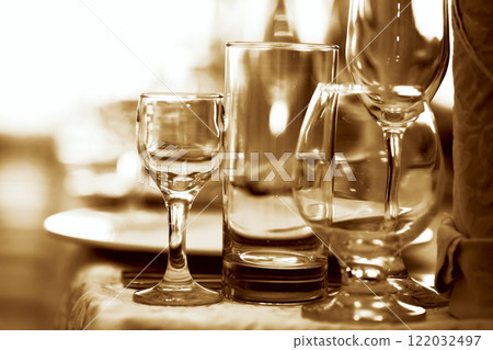 Glass goblets on the restaurant table tinted in brown. 122032497