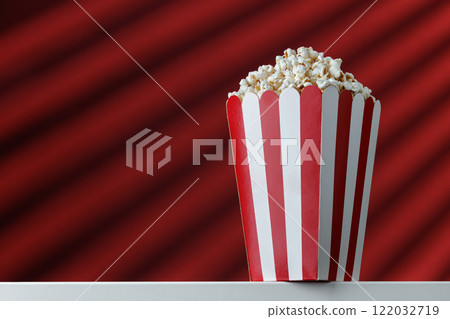 popcorn in striped box on red background popcorn in striped box on red background 122032719