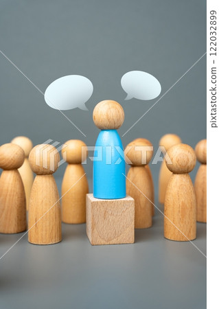 A human figure delivers a speech to the audience. Concept of a political leader or public figure. Freedom of speech and worldview. Demonstration, rally. 122032899